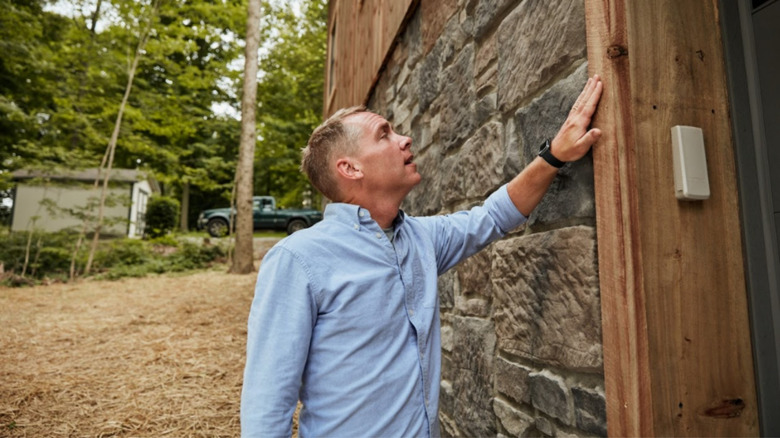 Clint Harp inspecting doorframe