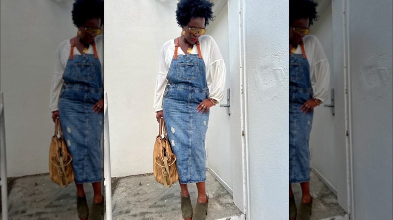 Denim over-dress worn with heeled clogs