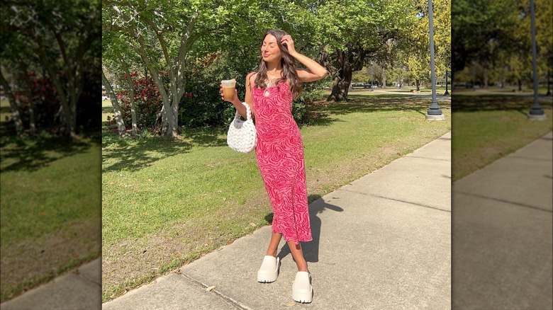 Patterned, pink maxi dress paired with platform clogs