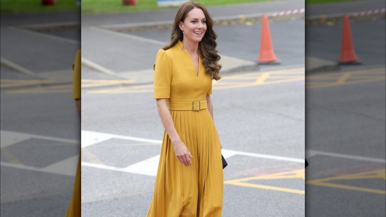 Kate Middleton walking in yellow dress