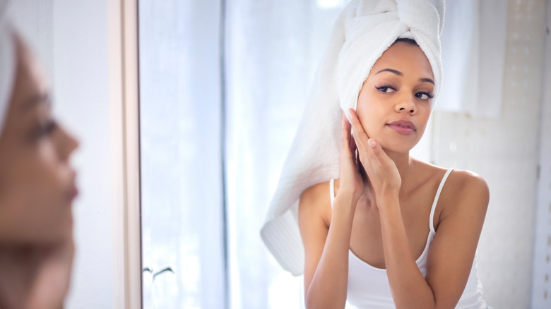 Woman looking in mirror post-shower