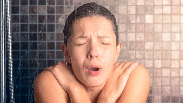 Woman taking a cold shower