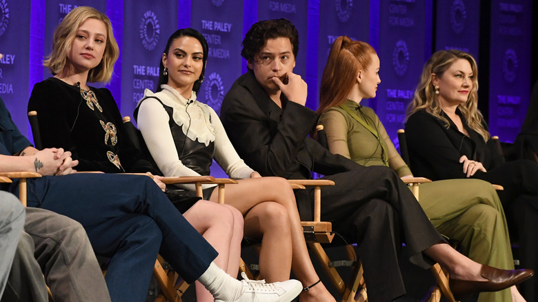 The cast of Riverdale sitting onstage