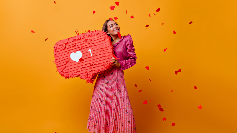 woman holding Instagram like heart