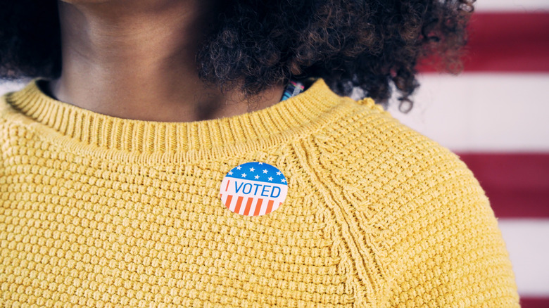 A woman wearing an I Voted sticker