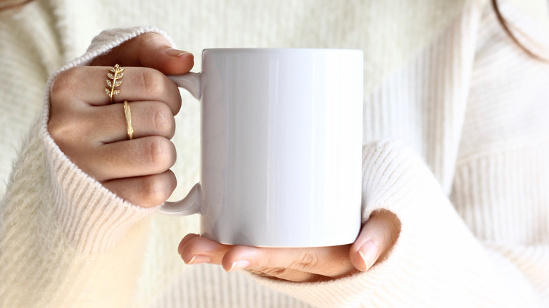 Holding a mug of coffee 