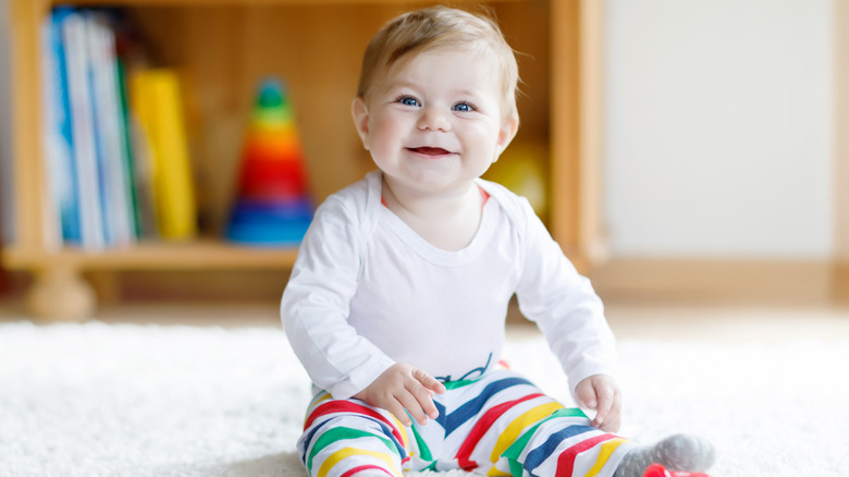 smiling baby with striped pants