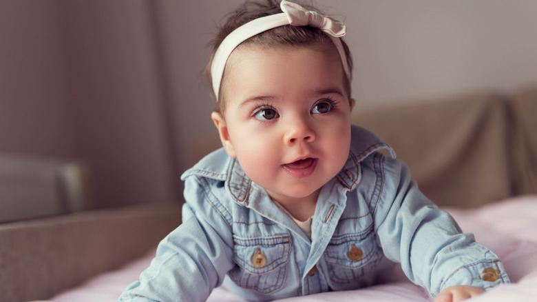 baby in jean jacket and bow headband