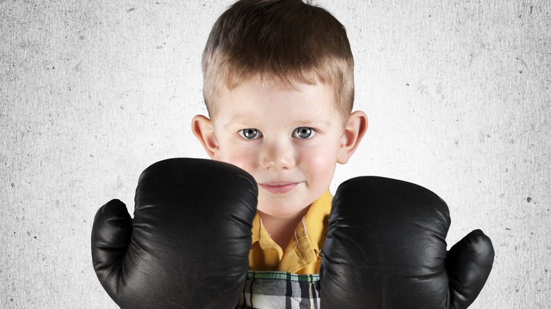 baby wearing boxing gloves