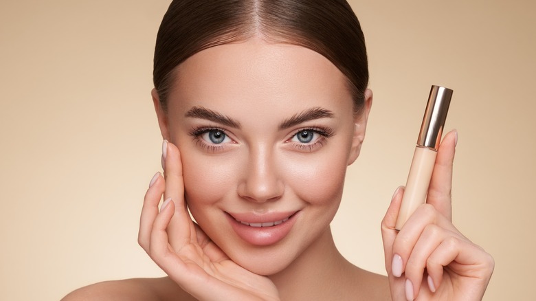 Woman holding concealer