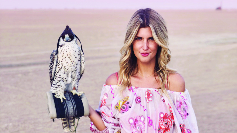 Anna Kloots posing with falcon in Dubai