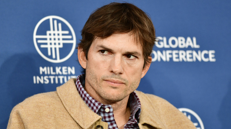 Ashton Kutcher looking sideways with serious expression