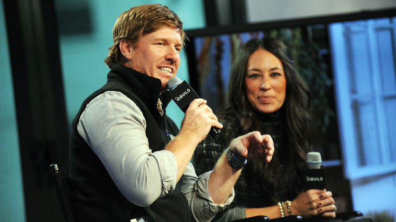 Chip and Joanna holding microphones