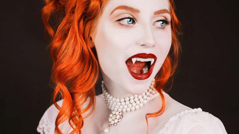 Woman in vampire costume posing 