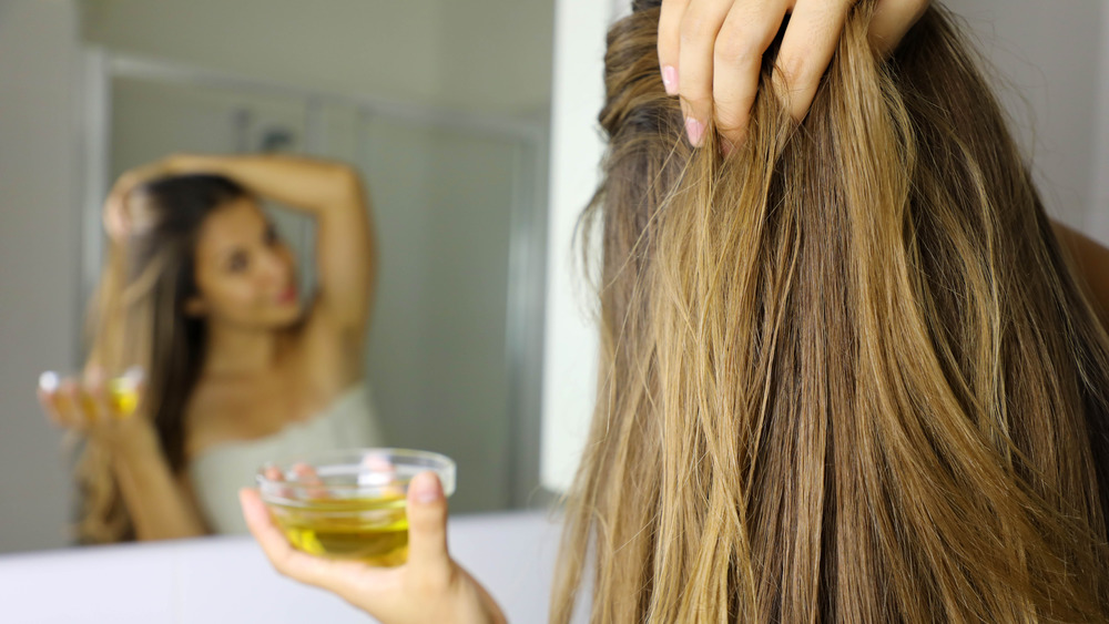 Woman adding avocado oil