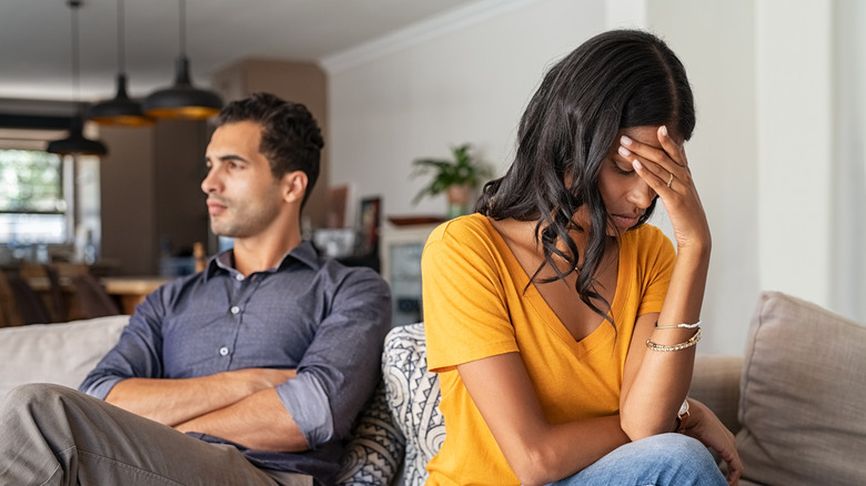 Couple faces away from each other on couch