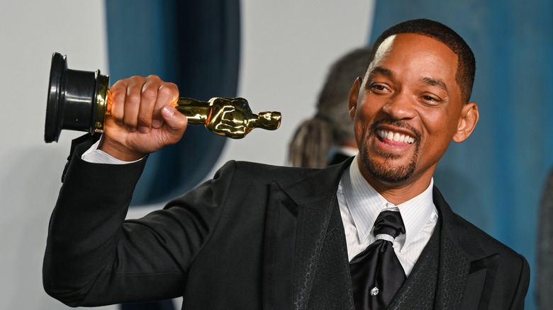 Will Smith holds up his Oscar