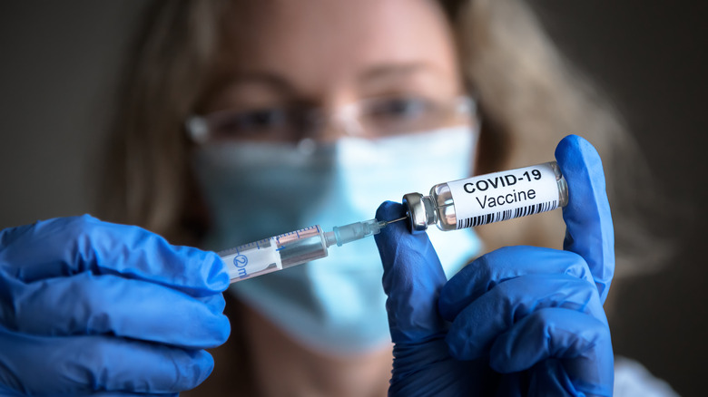 Doctor holds up Covid-19 vaccine