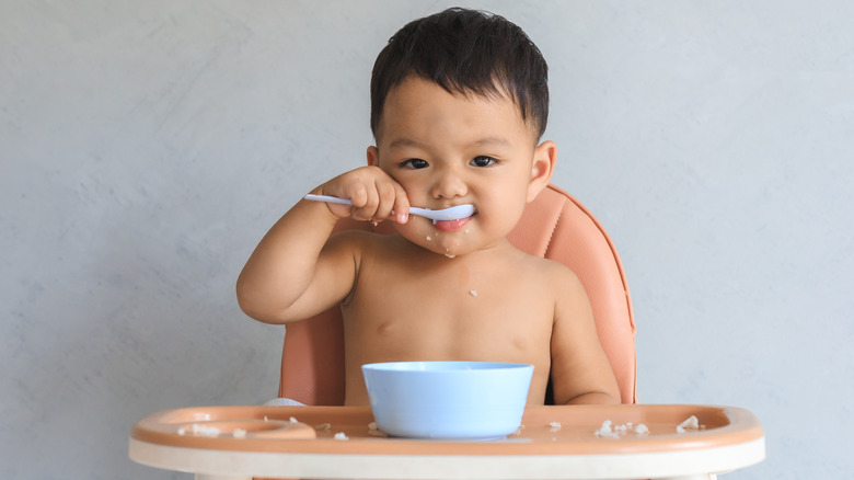 Baby boy eating cereal