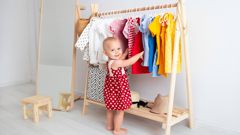 Baby girl playing with clothes