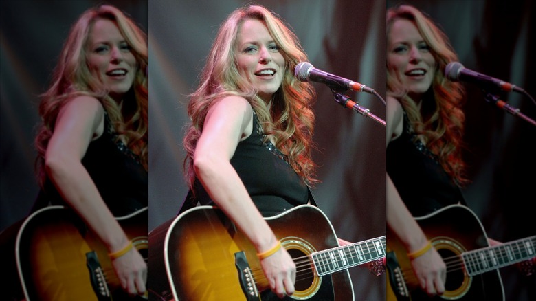 Deana Carter performing with a guitar