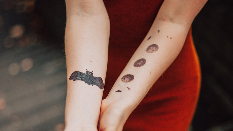 Woman with tattoos of the moon phases
