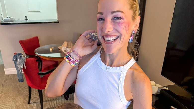 Lindsay Czarniak  shows off her pink heart facial glitter and friendship bracelets for the Taylor Swift concert.