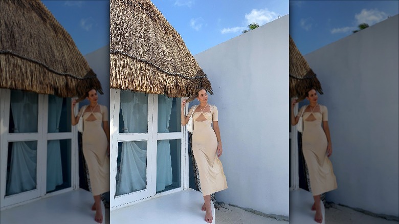 woman posing in neutral midi dress