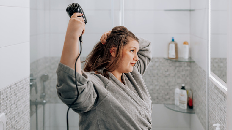 Woman blow-drying her hair