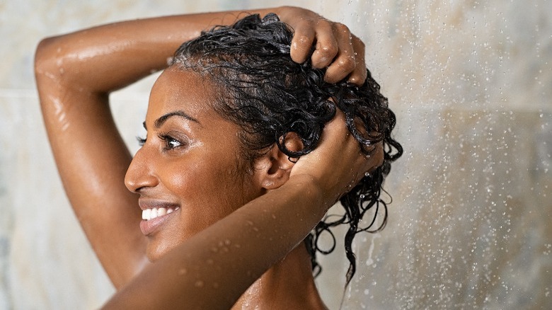 Woman using hair conditioner 