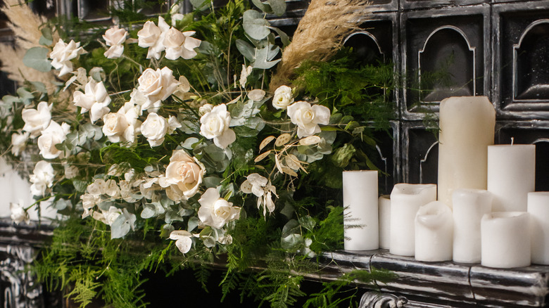 White roses white candles mantel