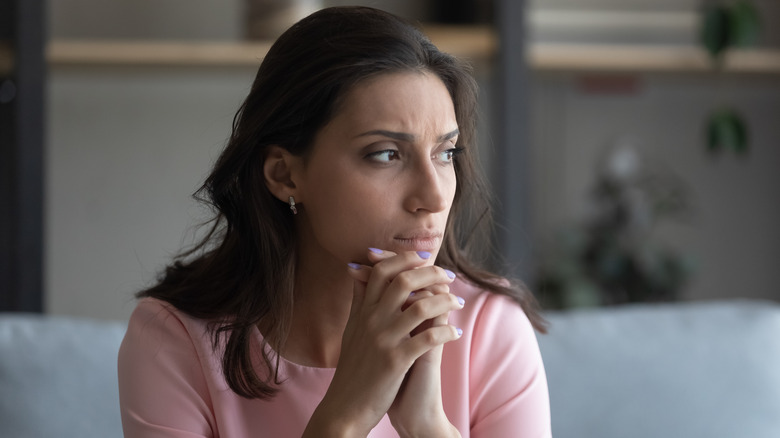 woman looking upset and looking off-camera