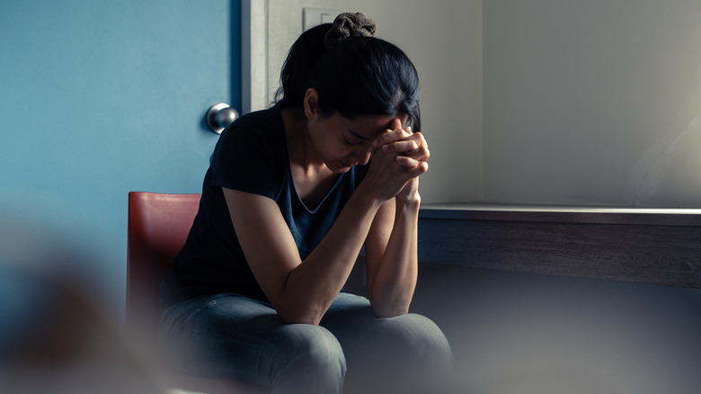 young woman upset with her head on her hands