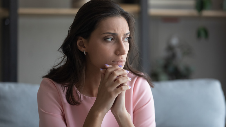 young Arabic woman looking upset and staring off-camera