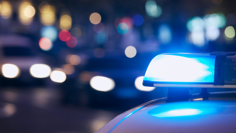 blue lights flashing on top of a police cruiser