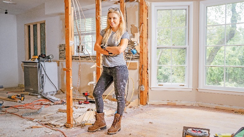 Cristy Lee posing in a demolished home