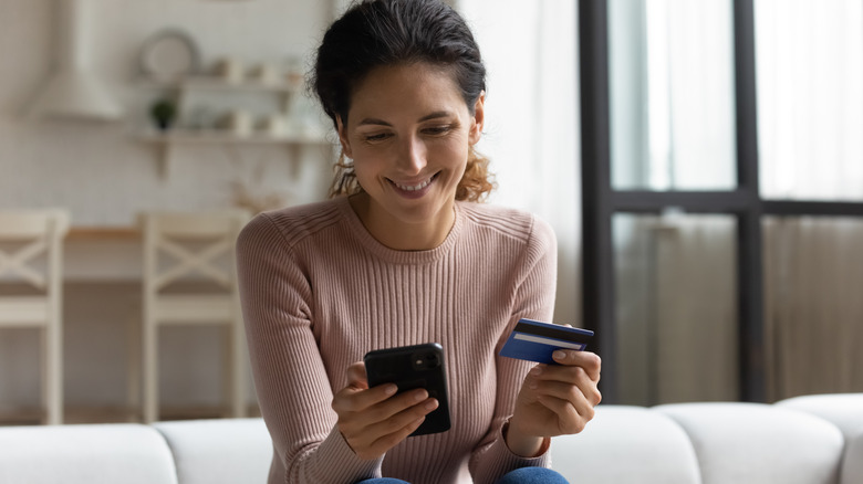 A woman shopping online using a credit card