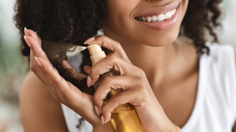 Woman spraying hair product