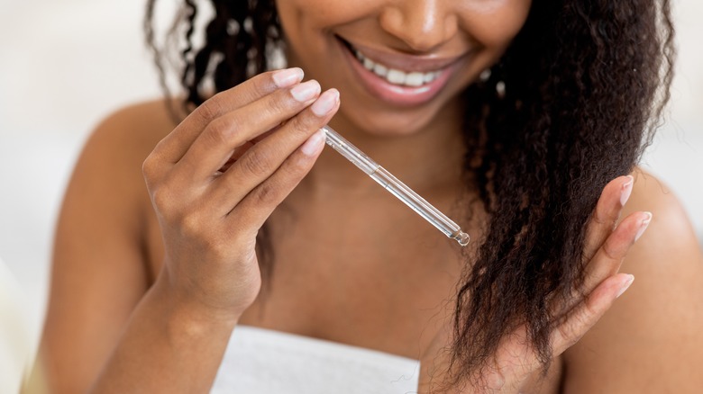 Woman applying hair oil