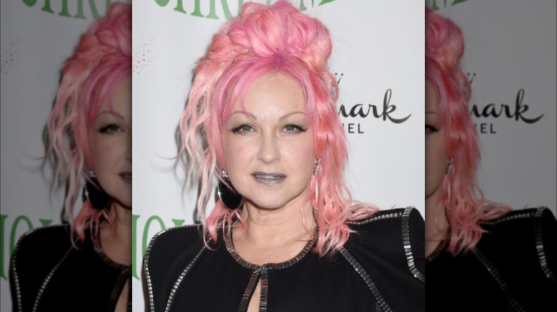 Cyndi Lauper posing with pink hair