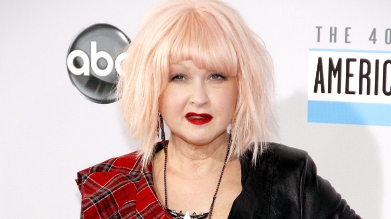 Cyndi Lauper posing with peach blonde hair