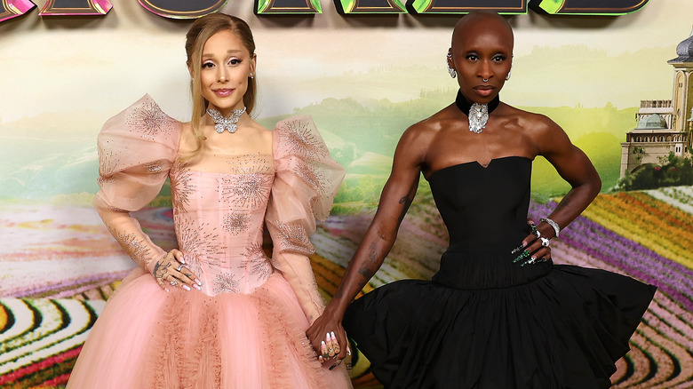 Ariana Grande and Cynthia Erivo hold hands at a "Wicked" event