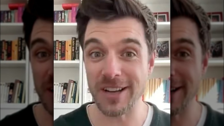 Dan Jeannotte in front of a bookshelf