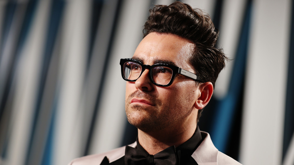 Dan Levy posing in black bow tie