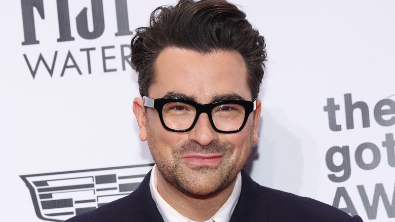 Dan Levy smiling