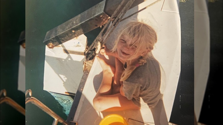 Ella Loudon as a child on a boat