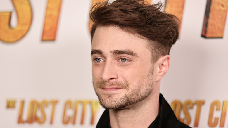 Harry Potter's Daniel Radcliffe smiling on the red carpet 