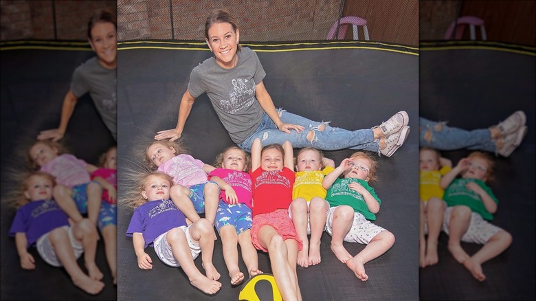 Danielle Busby sitting with 6 daughters