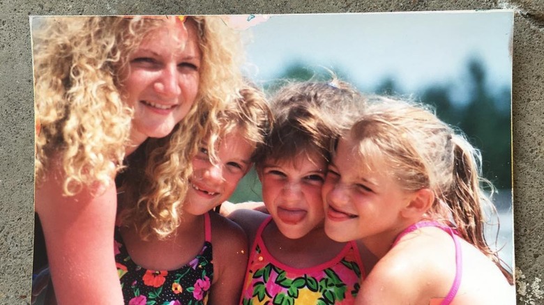 Danielle Busby as a child with her sisters and mom 