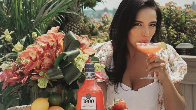 Danielle Olivera holding 1800 Tequila's Ultimate Margarita Strawberry